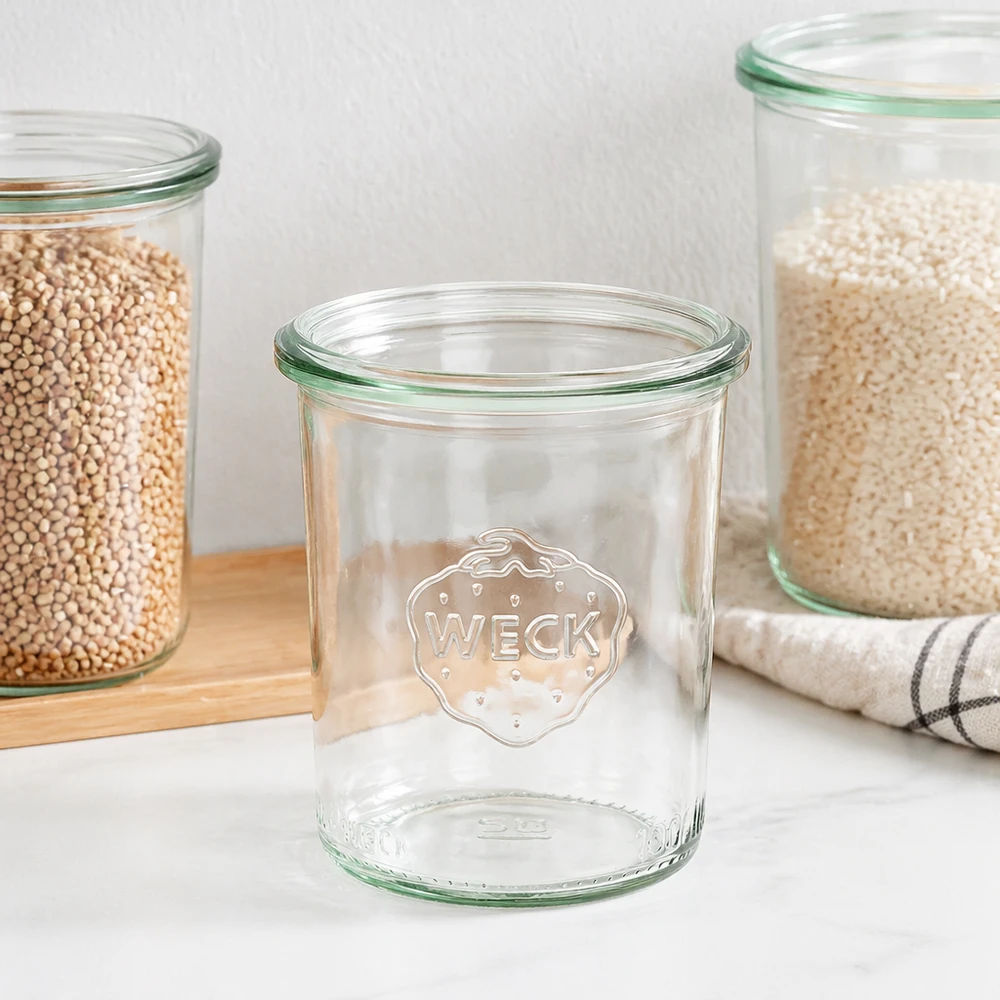 WECK 160ml RR60 mason jar met groene rand en logo, lege mason jar naast gevulde voorraadpotten op houten plank